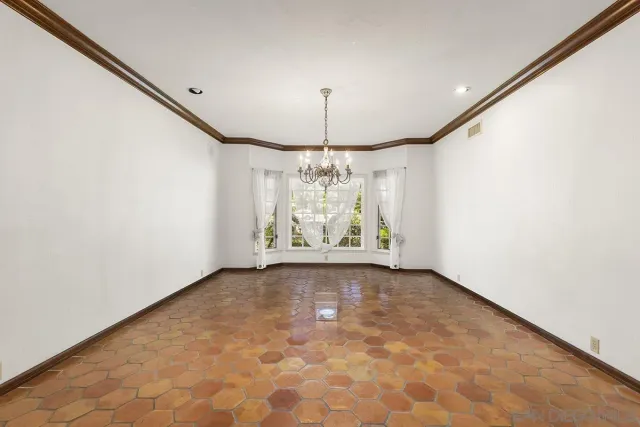 a view of empty room with fireplace and wooden floor