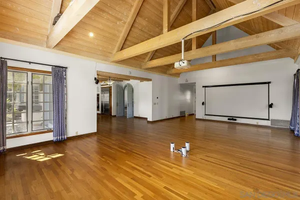 a kitchen with stainless steel appliances kitchen island granite countertop a table chairs in it and wooden floors