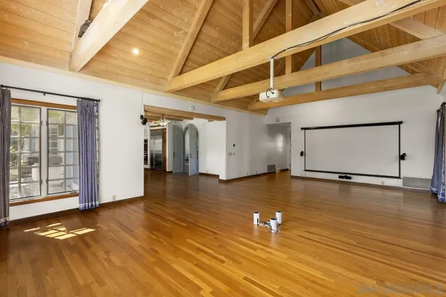 a kitchen with stainless steel appliances kitchen island granite countertop a table chairs in it and wooden floors