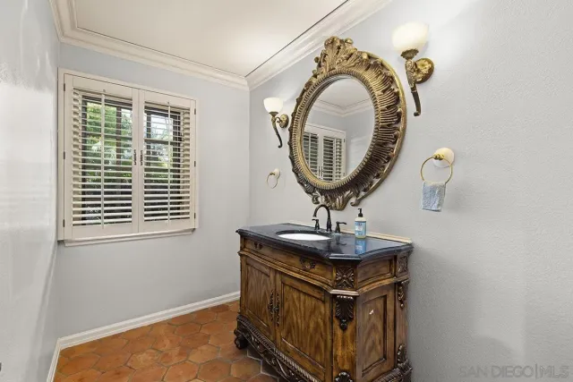 a view of a hallway with wooden floor and windows