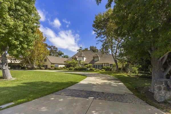 a view of house with yard in front of house