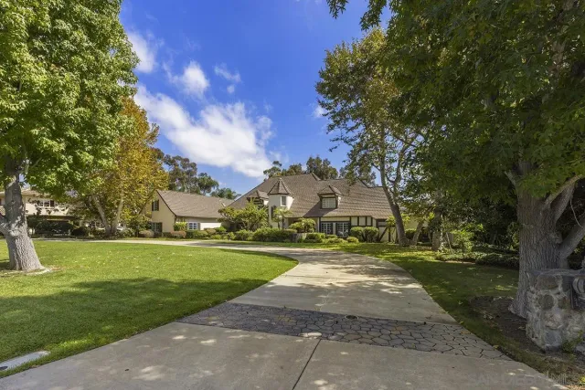 a view of house with yard in front of house