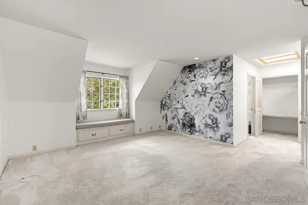 an empty room with closet area