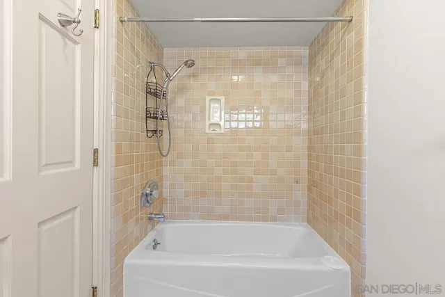 a bathroom with a sink a mirror and shower