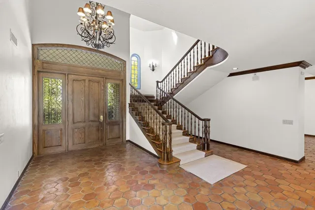 an empty room with windows and fireplace