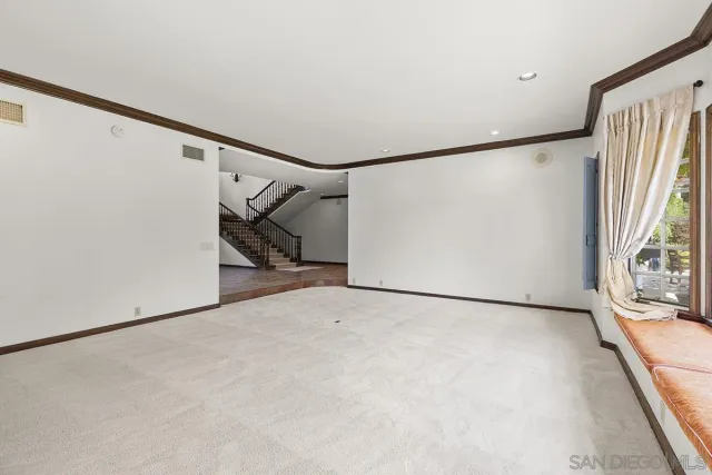 a view of a room with window and chandelier