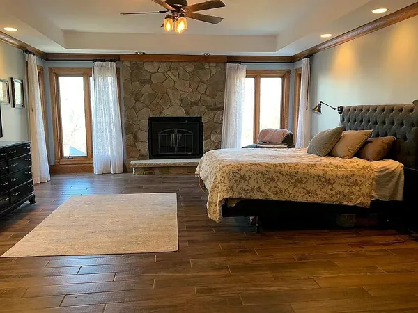 a spacious bedroom with a bed and a fireplace