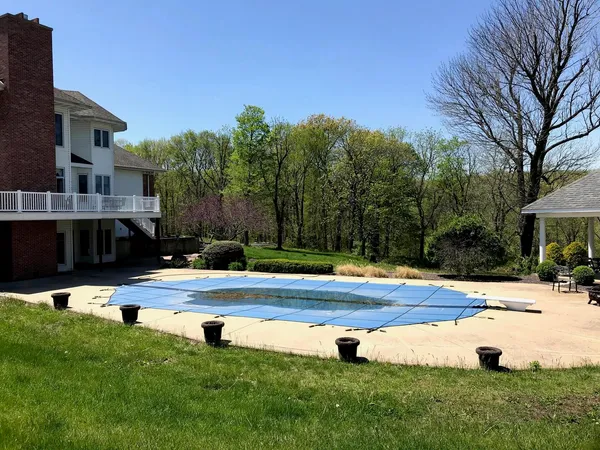 a view of a swimming pool with a yard