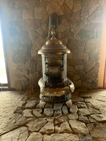 a living room with couches rug and a flat screen tv