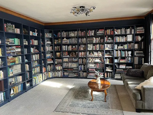 a living room with fish tank and a book shelf