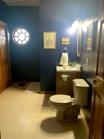 a bathroom with a toilet sink and mirror