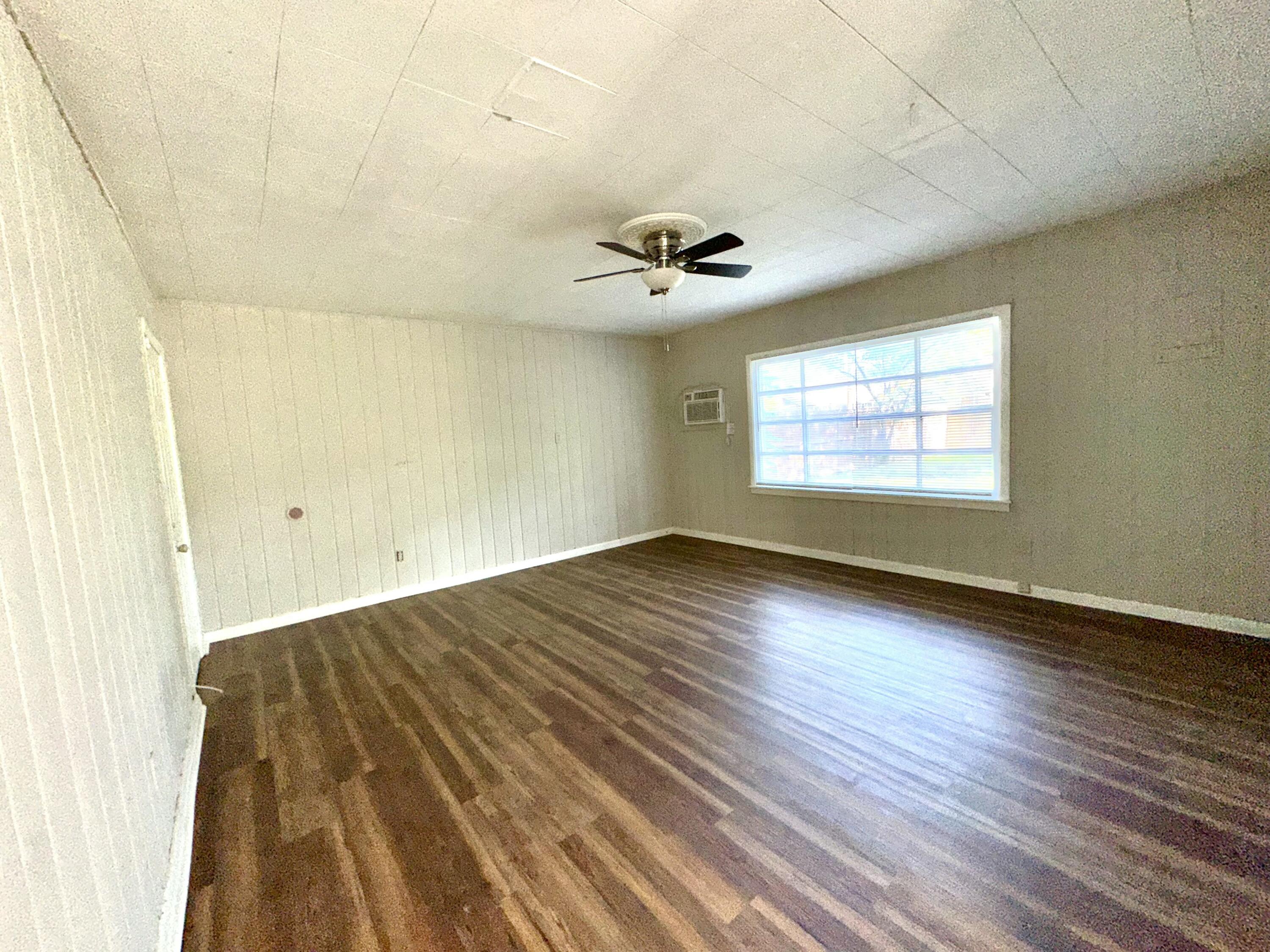 3012 22nd Street Lubbock, TX 79410 - Photo 6 of 11 wooden floor in an empty room with a window