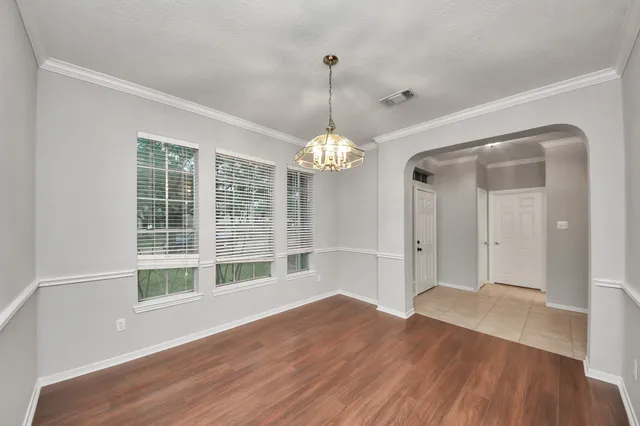 a view of livingroom with window wooden floor and chandelier