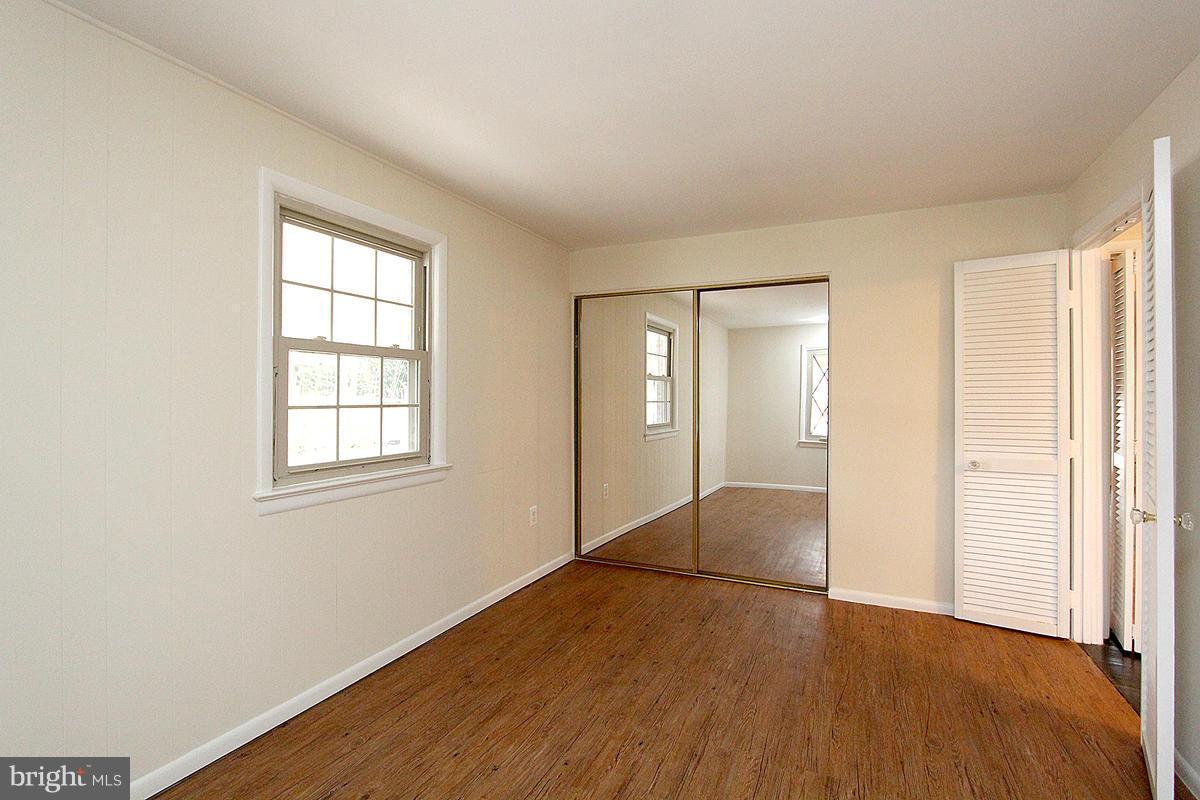 12917 Layhill Road Silver Spring, MD 20906 - Photo 14 of 30 an empty room with wooden floor and windows