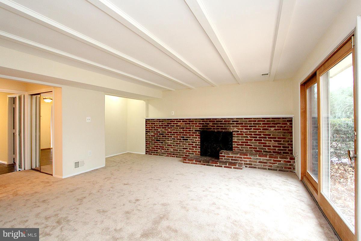 12917 Layhill Road Silver Spring, MD 20906 - Photo 16 of 30 a view of an empty room with a fireplace and a window