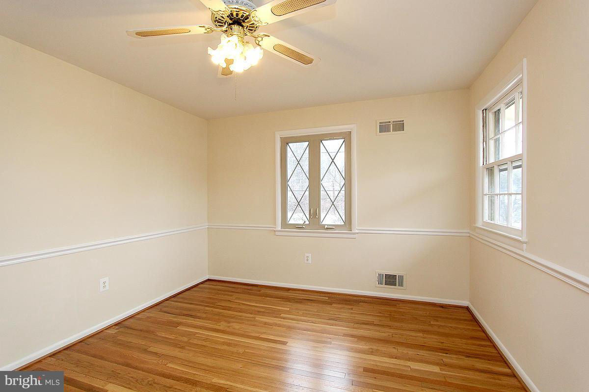 12917 Layhill Road Silver Spring, MD 20906 - Photo 18 of 30 a view of an empty room with wooden floor and a window