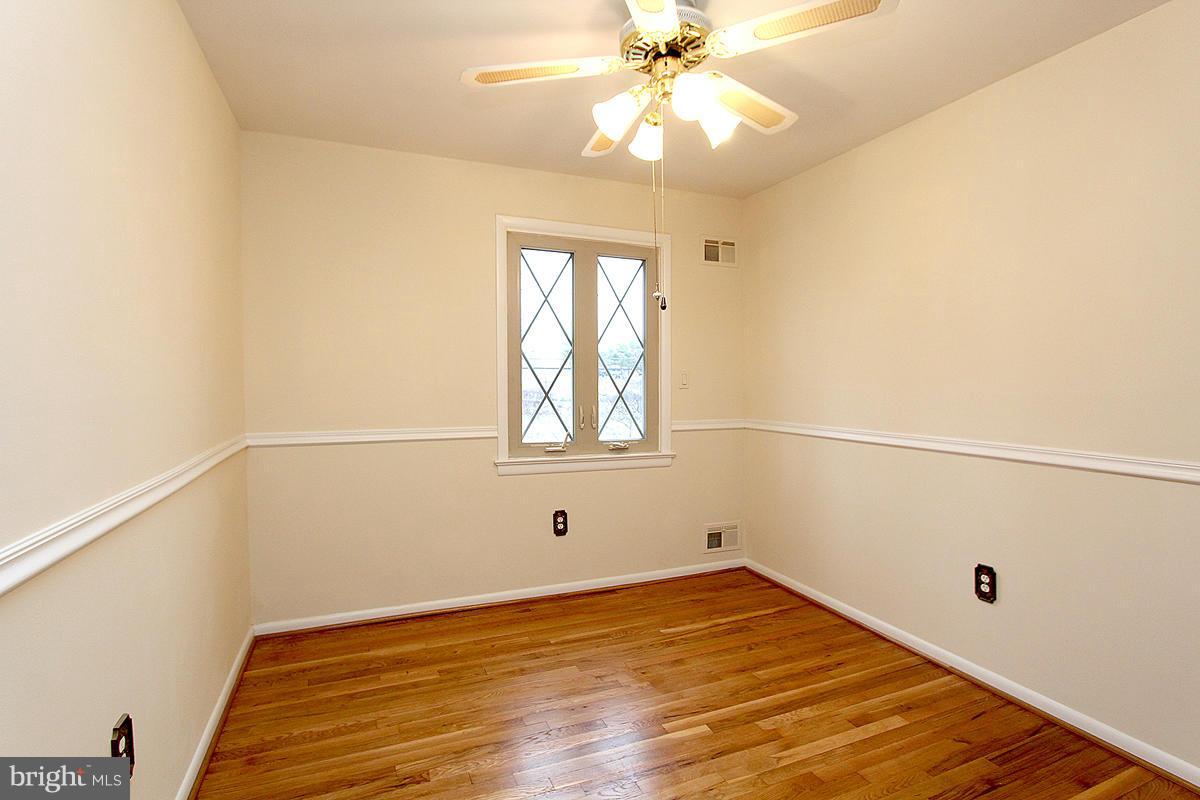 12917 Layhill Road Silver Spring, MD 20906 - Photo 19 of 30 an empty room with a window and ceiling fan