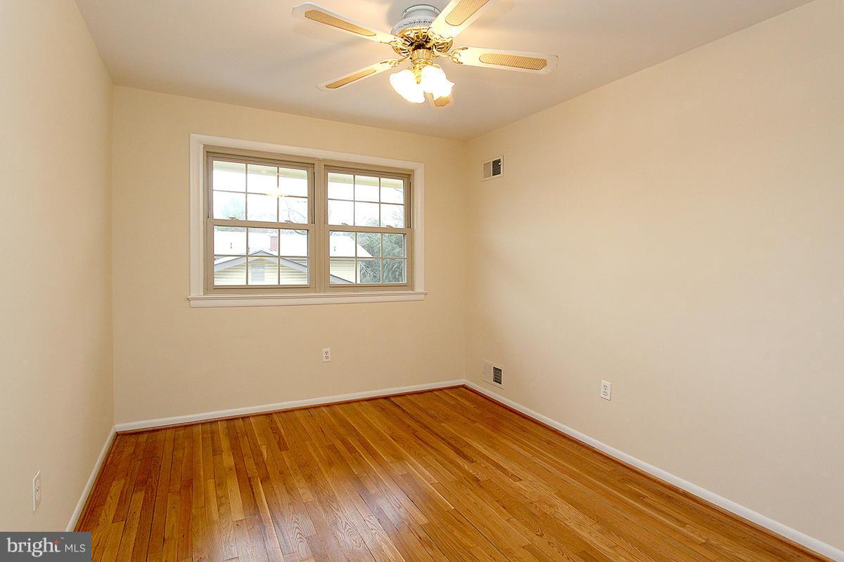 12917 Layhill Road Silver Spring, MD 20906 - Photo 21 of 30 an empty room with a window and wooden floor