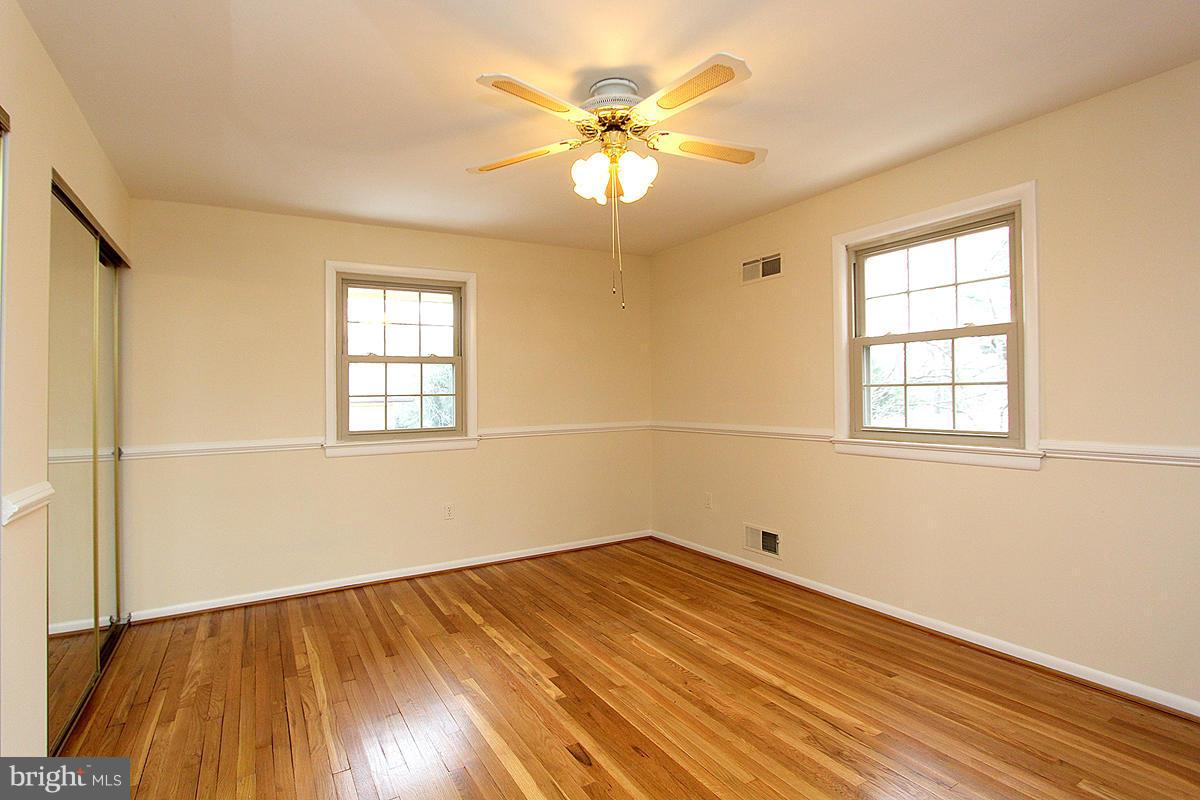 12917 Layhill Road Silver Spring, MD 20906 - Photo 22 of 30 wooden floor in an empty room with a window