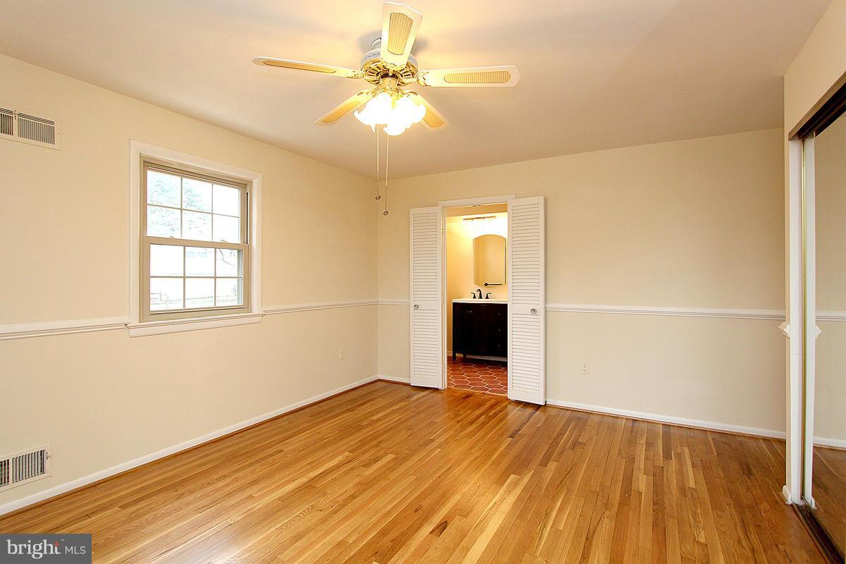 12917 Layhill Road Silver Spring, MD 20906 - Photo 23 of 30 wooden floor in an empty room with a window