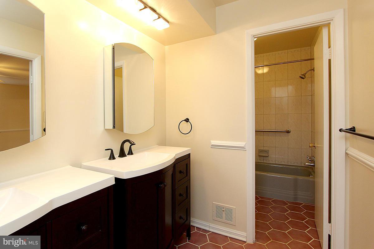12917 Layhill Road Silver Spring, MD 20906 - Photo 25 of 30 a bathroom with a sink and a mirror