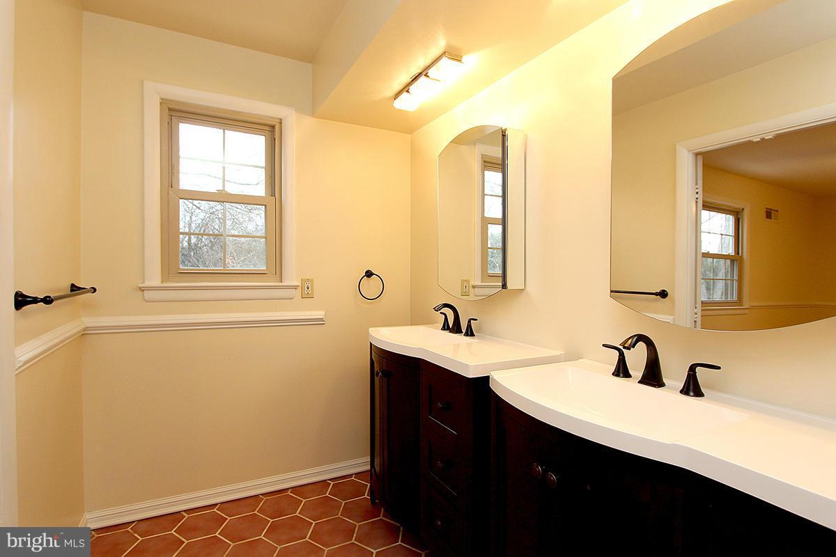 12917 Layhill Road Silver Spring, MD 20906 - Photo 26 of 30 a bathroom with a sink and a mirror