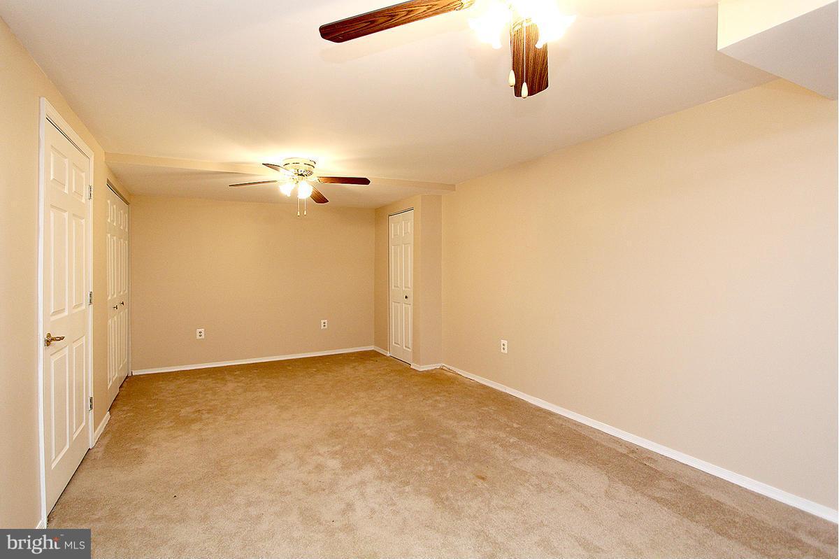 12917 Layhill Road Silver Spring, MD 20906 - Photo 27 of 30 an empty room with a chandelier fan