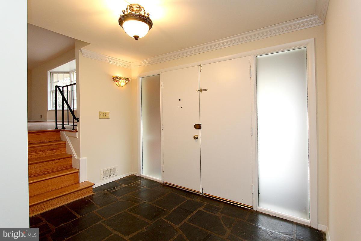 12917 Layhill Road Silver Spring, MD 20906 - Photo 4 of 30 a view of a hallway with wooden floor and staircase