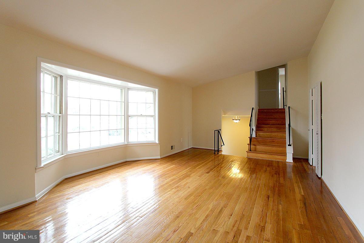 12917 Layhill Road Silver Spring, MD 20906 - Photo 6 of 30 a view of an empty room with wooden floor and a window