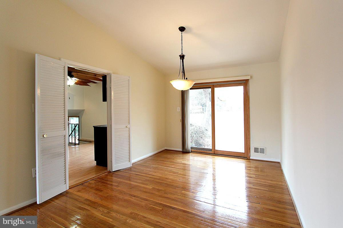 12917 Layhill Road Silver Spring, MD 20906 - Photo 7 of 30 a view of an empty room with wooden floor and a window