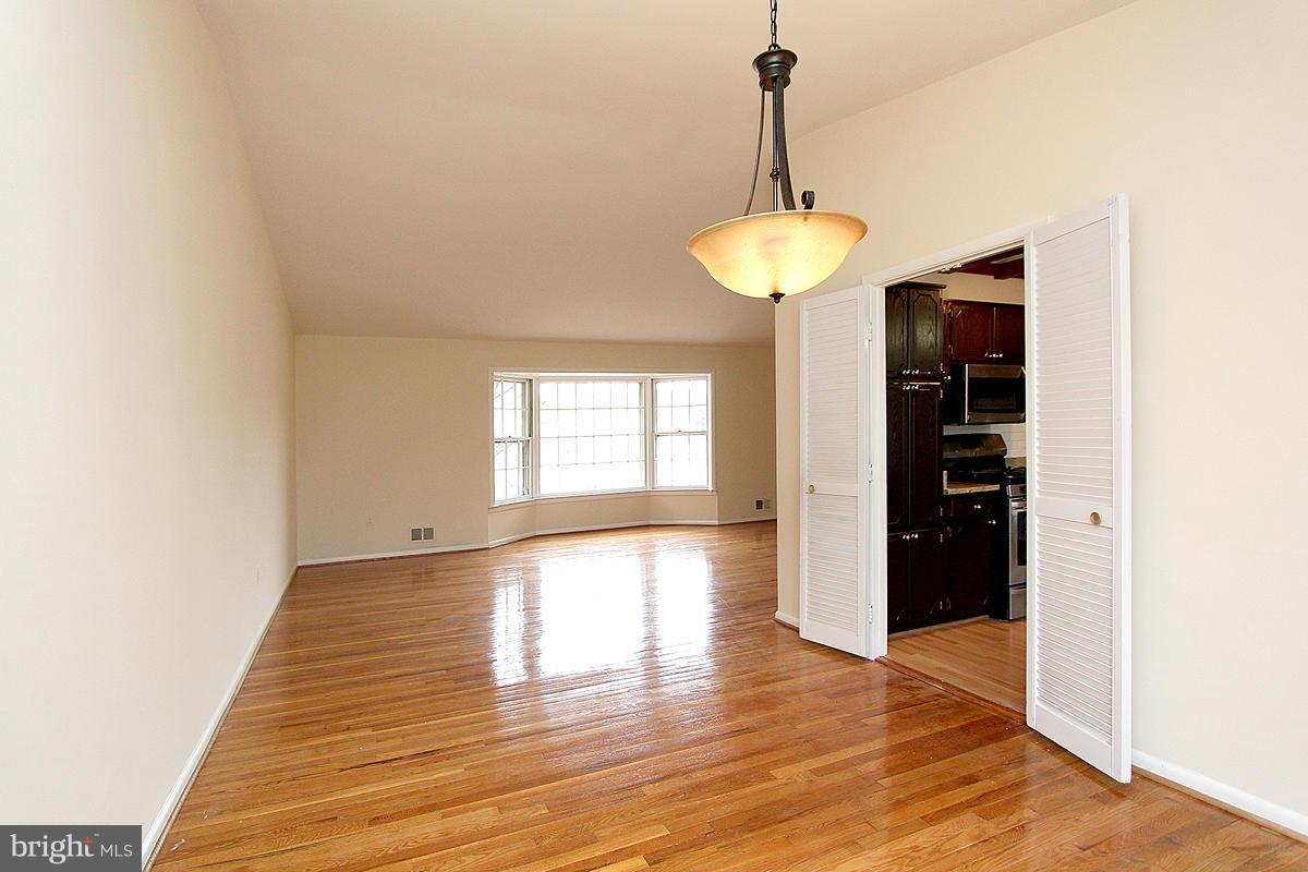 12917 Layhill Road Silver Spring, MD 20906 - Photo 8 of 30 a view of an empty room with wooden floor and a window