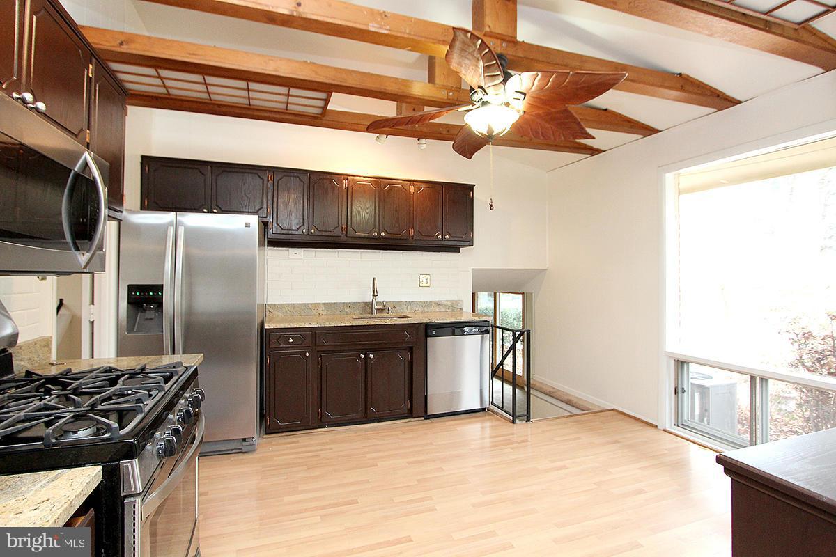 12917 Layhill Road Silver Spring, MD 20906 - Photo 9 of 30 a kitchen with stainless steel appliances granite countertop a sink stove and refrigerator