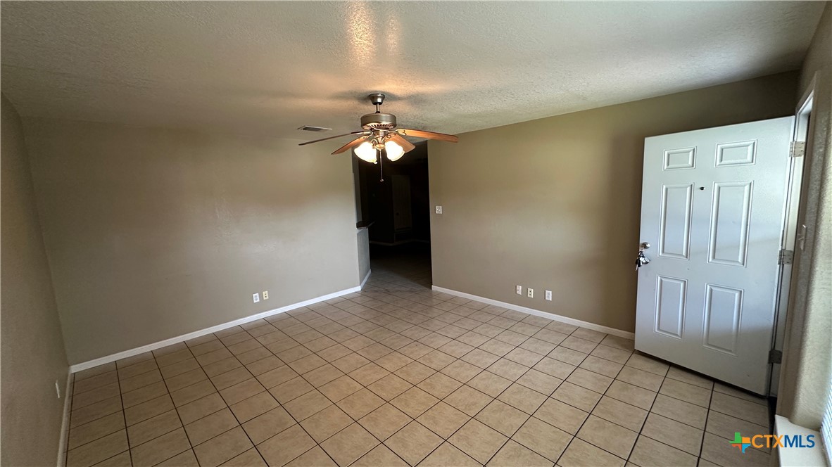 3209 Baldwin Loop, Unit A Killeen, TX 76549 - Photo 4 of 9 an empty room with chandelier fan