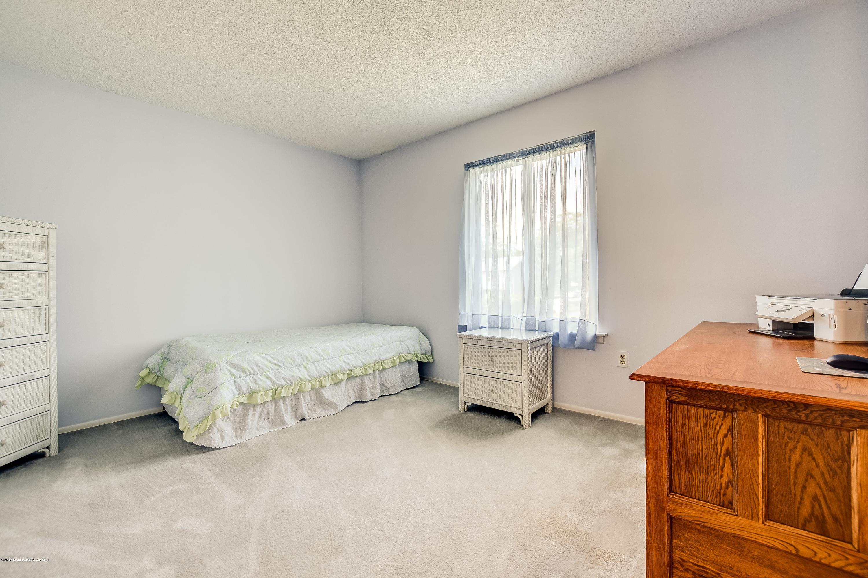 127 Reflection Road Toms River, NJ 08753 - Photo 14 of 20 a spacious bedroom with a bed and a window