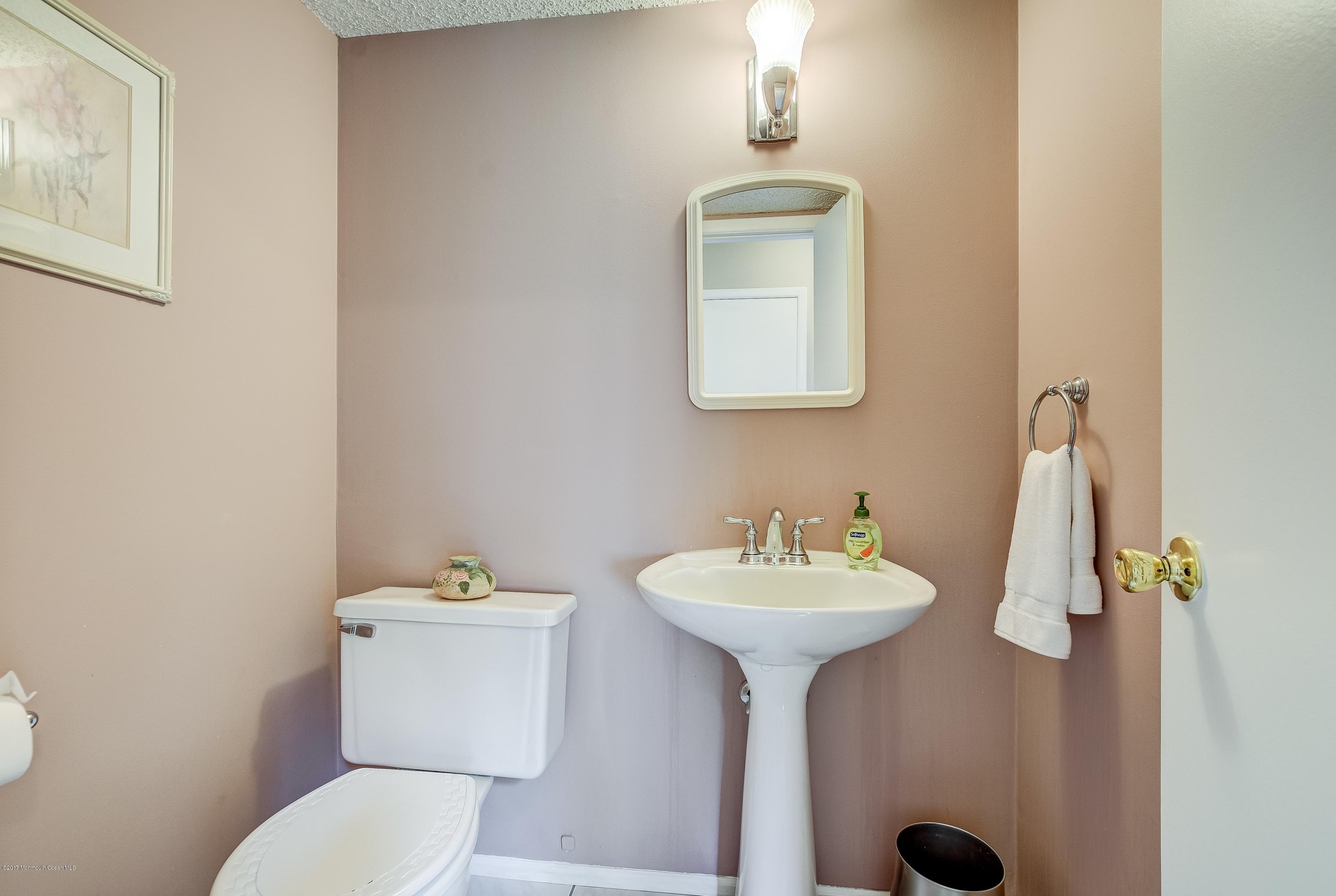 127 Reflection Road Toms River, NJ 08753 - Photo 16 of 20 a bathroom with a sink toilet and a mirror