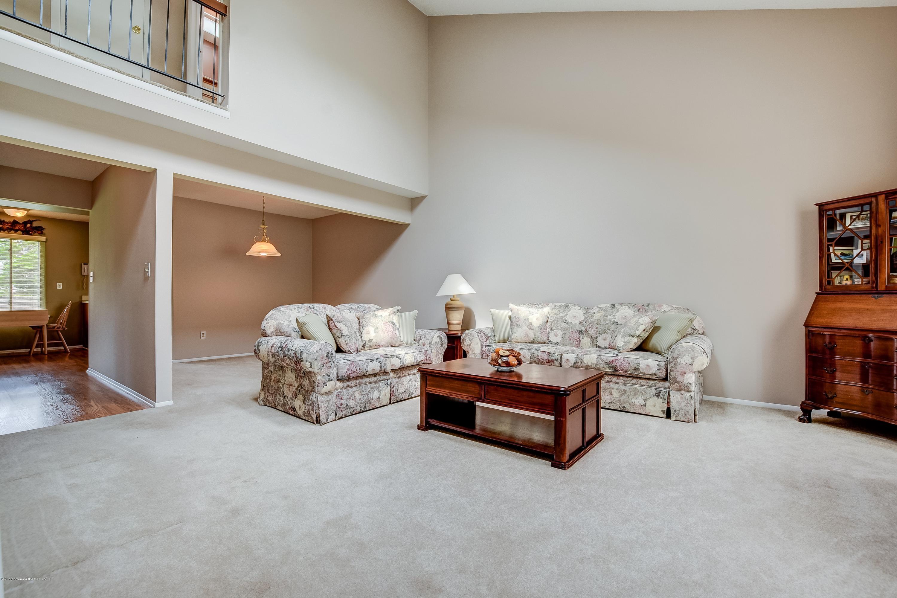 127 Reflection Road Toms River, NJ 08753 - Photo 2 of 20 a spacious bedroom with a bed and a couch