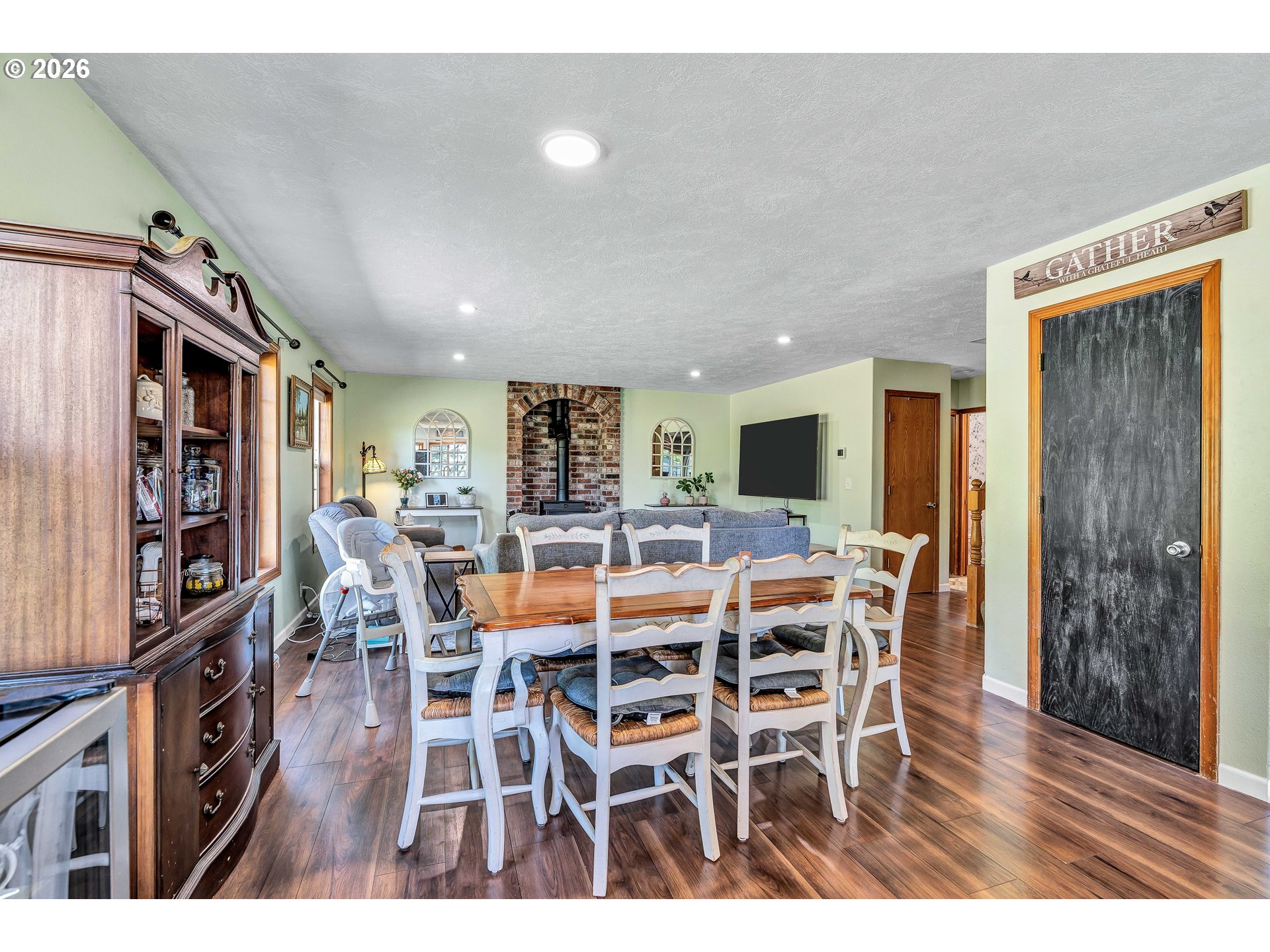 12313 South Groshong Road Molalla, OR 97038 - Photo 8 of 48 a view of a dining room with furniture and wooden floor