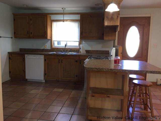 381 Oak Ridge Road Ellenville, NY 12428 - Photo 2 of 6 a kitchen with a sink cabinets and a wooden floor