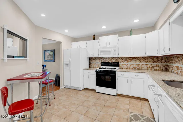 a kitchen with stainless steel appliances kitchen island granite countertop a sink and cabinets