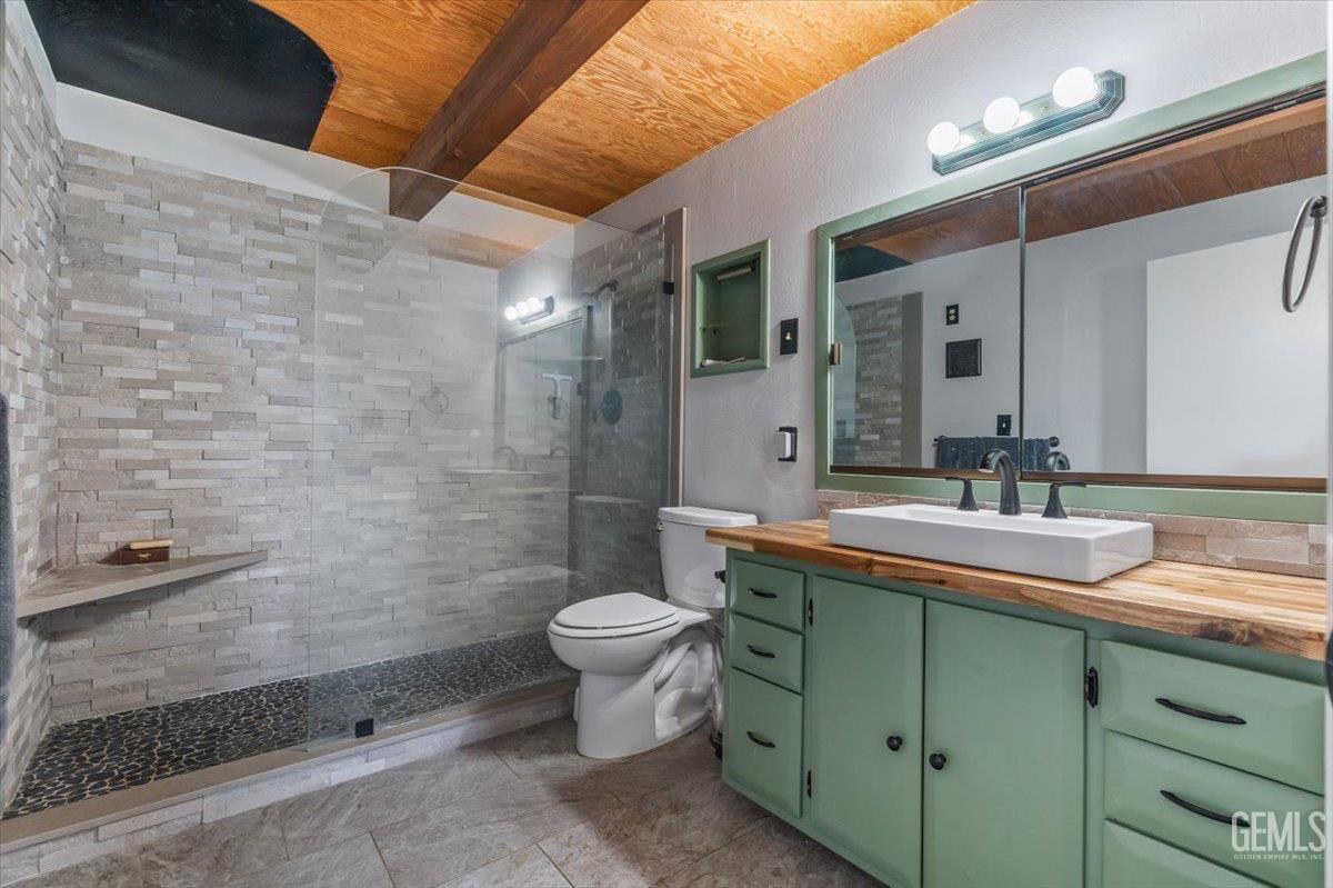 Undisclosed Address Tehachapi, CA 93561 - Photo 16 of 30 a bathroom with a double vanity sink toilet and shower