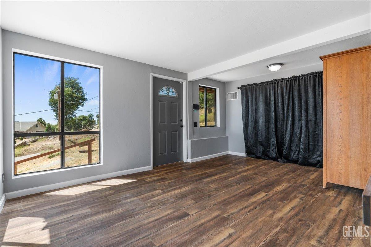 Undisclosed Address Tehachapi, CA 93561 - Photo 22 of 30 a view of an empty room with wooden floor and a window