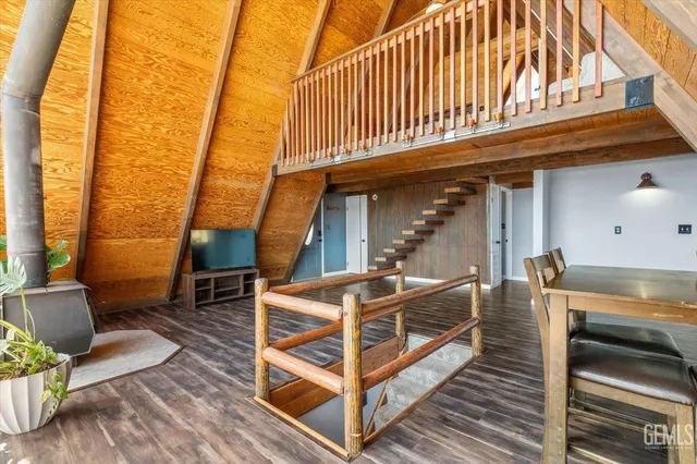 a view of a patio with table and chairs with wooden floor and fence