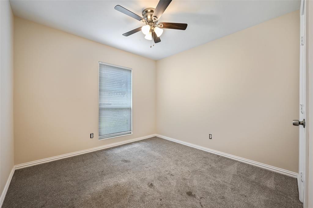 7318 Emory Oak Lane Dallas, TX 75249 - Photo 24 of 28 Neutral tone wall finish with a window featuring horizontal blinds
