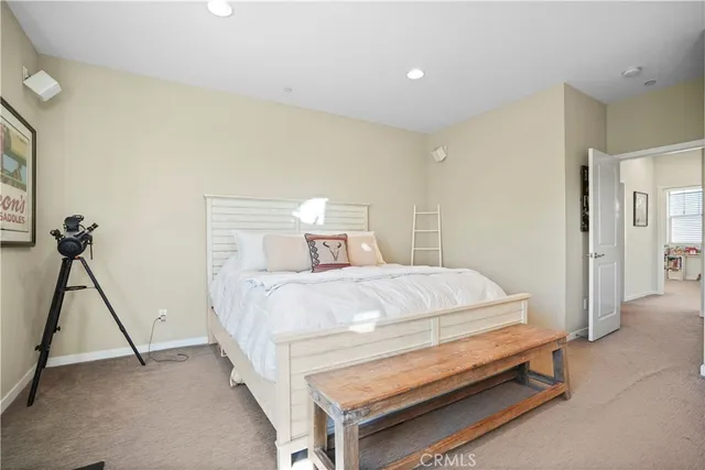 a bedroom with a large bed and a dresser