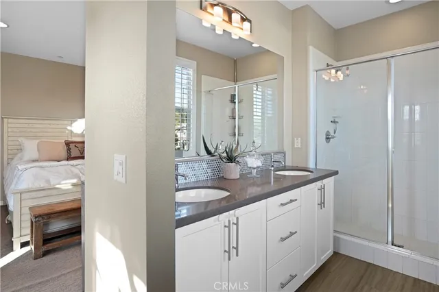 a bathroom with double vanity and a mirror