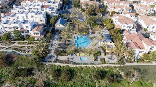 an aerial view of a house with a yard and wooden fence