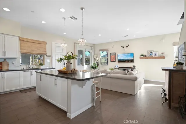 a kitchen with a sink a counter and chairs