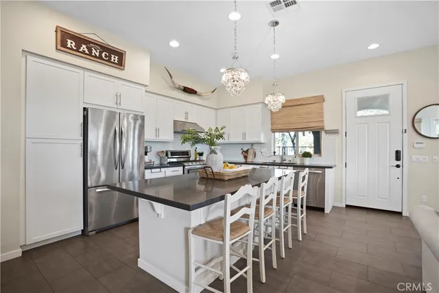 a living room with lots of furniture and kitchen view