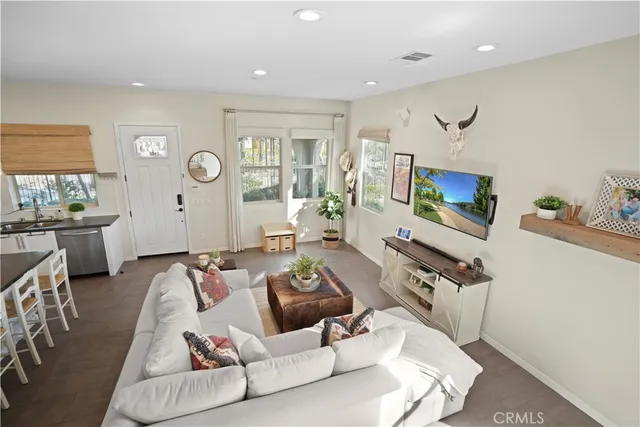 a bathroom with a granite countertop sink a mirror and a picture on the wall
