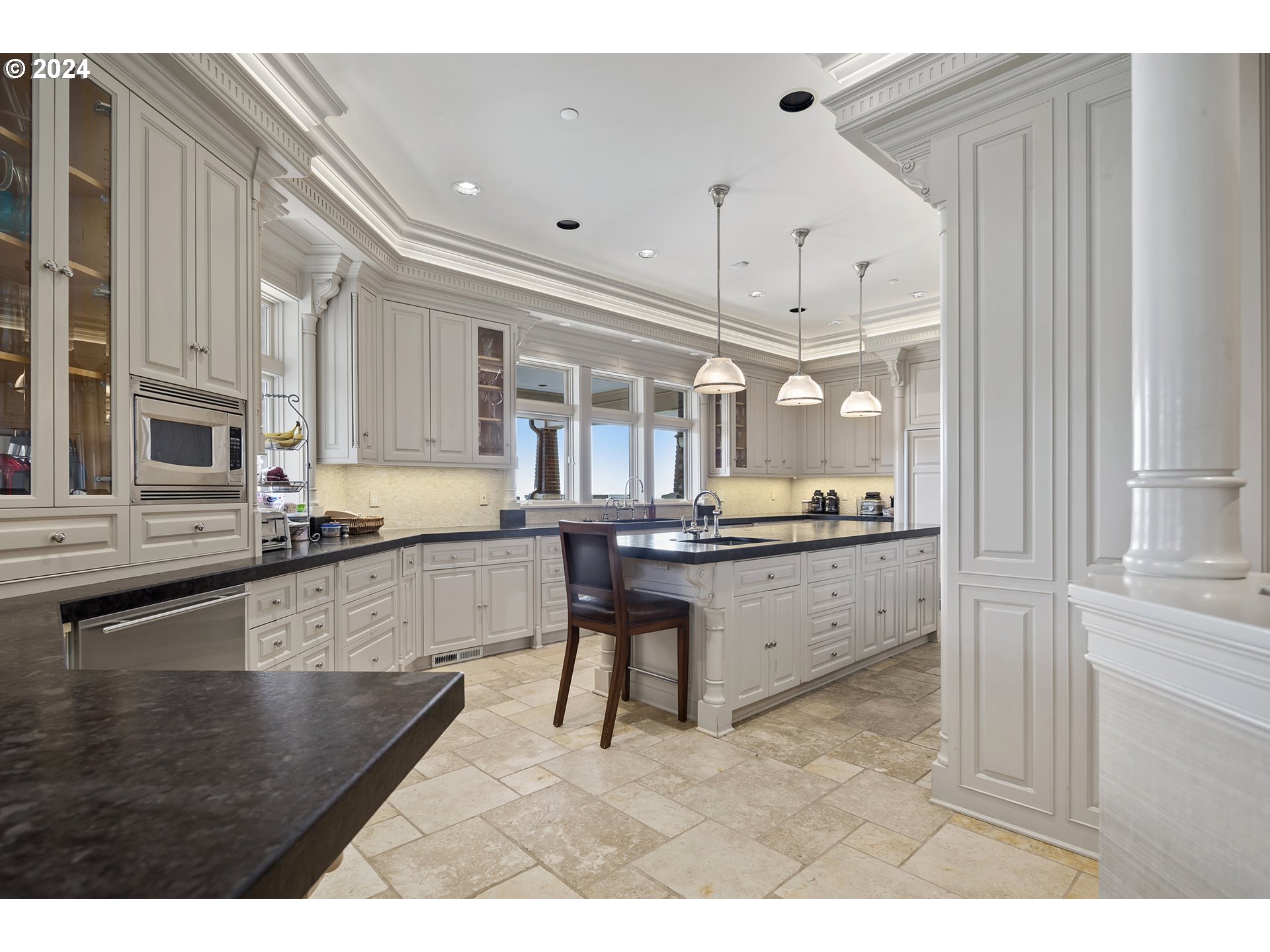 11223 Northwest Saltzman Road Portland, OR 97229 - Photo 19 of 46 a large white kitchen with stainless steel appliances kitchen island granite countertop a large counter top and a stove